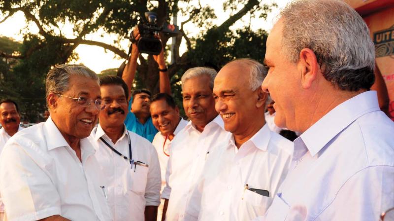 Chief Minister Pinarayi Vijayan greets Michalis Papanikalov (general secretary, Unions International of Building, Wood, Building Materials and Industries) at its global convention in Thrissur on Sunday. (Photo: DC)