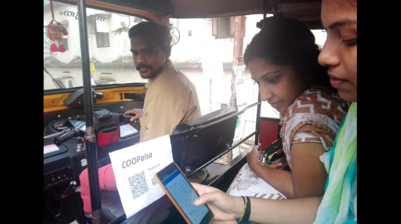 A customer pays taxi fare using Coopaisa.