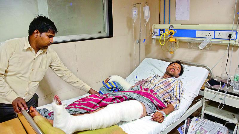 A relative attends to Rajesh Kumar, 28, who was attacked by a group of people while returning from a rally, at a government hospital in Meerut, on Wednesday. Police rushed forces and arrested dozens of people to stop clashes that erupted when upper caste Hindus allegedly fired on Dalits on Wednesday. (Photo: AP)