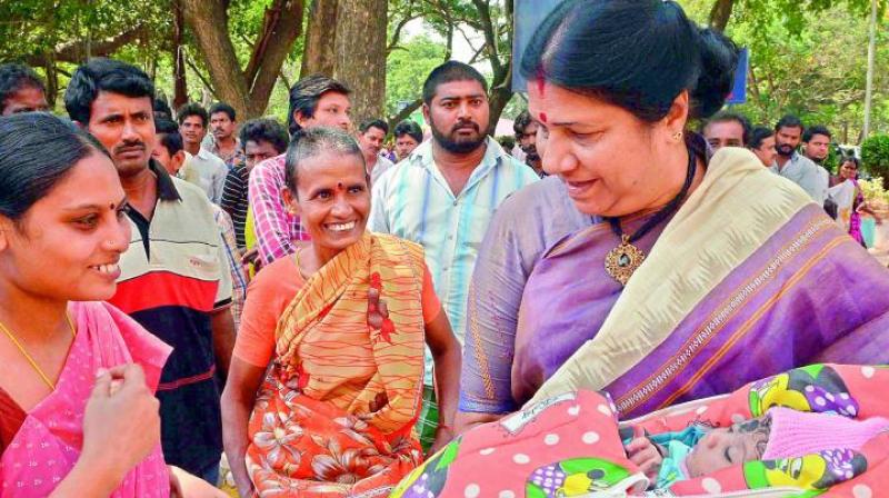 Womens panel chairperson Nannapaneni Rajakumari cradles a newborn during her visit to the Old Government Hospital in Vijayawada. (File Photo)
