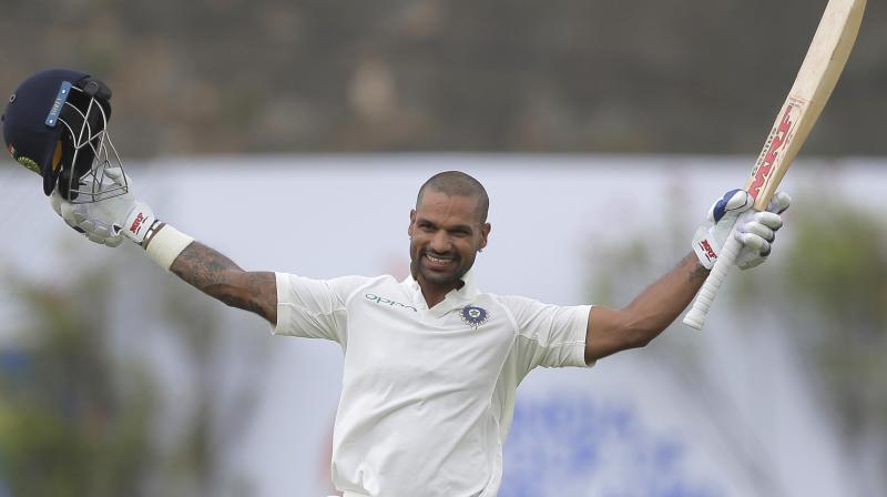 Indias Shikhar Dhawan celebrates scoring a century during the first days play of the first test cricket match between India and Sri Lanka in Galle, Sri Lanka. (Photo: AP)