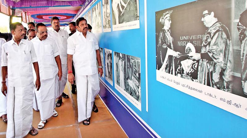 CM Edappadi Palaniswami, flanked by Assembly Speaker Dhanapal and minister O.S. Manian takes a look at the exhibits in the exclusive gallery of photographs of late CM Dr MGR set up at the municipal ground in Tiruvannamalai (Photo: DC)