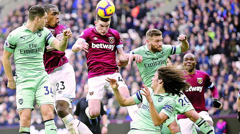 West Hams Declan Rice (centre) tries to head the ball at the goal in their English Premier League match against Arsenal at the London Stadium on Saturday. West Ham won 1-0. (Photo: AP)