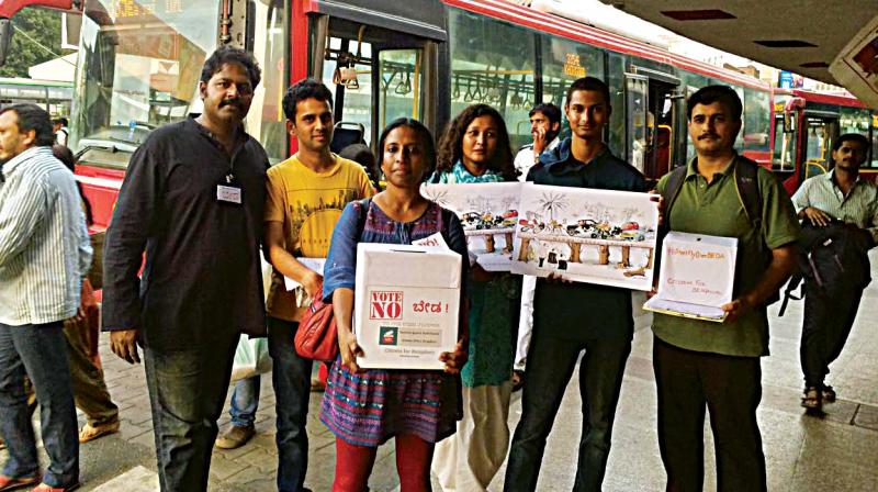 Bengalureans against the steel flyover, canvas for support at Majestic bus station in Bengaluru on Saturday. (Photo: DC)