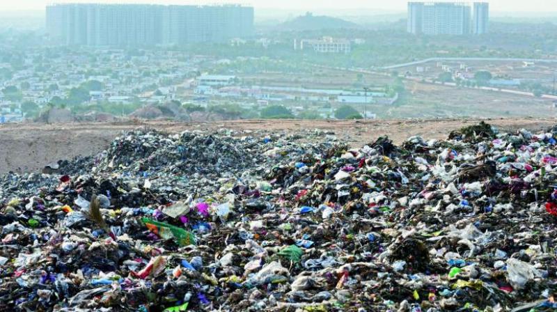 Huge amount garbage piled up at the dumping yard at Kapulauppada in Visakhapatnam on Tuesday.