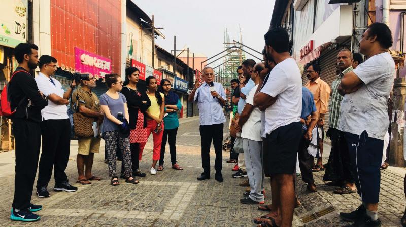 Abdul Rehman, a merchant of SM Street, explains the rich heritage of the street to the walk team members at Kozhikode on Saturday.