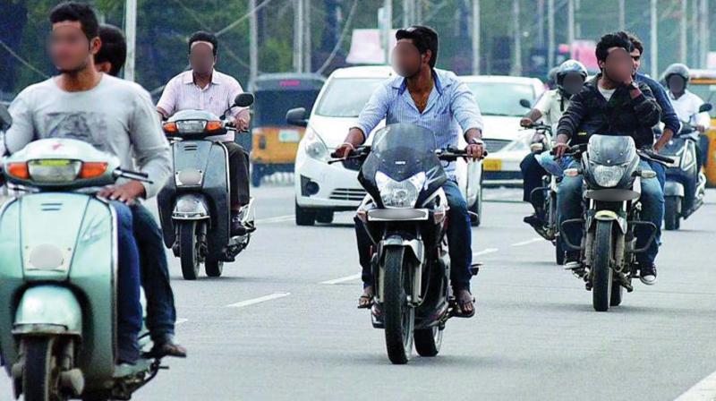 Many riders can be seen without a helmet on city roads in this file photo.