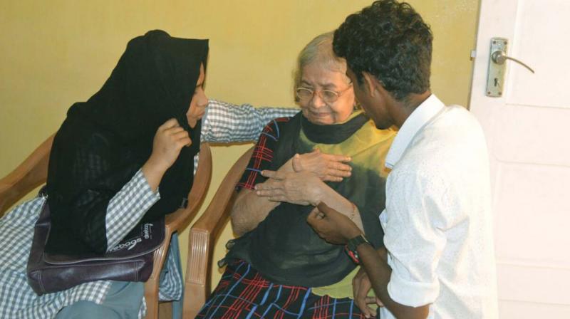 Our Hope Society members with an elderly woman at St Agnes Old Age Home in Fort Kochi. The charity provided food for the inmates.