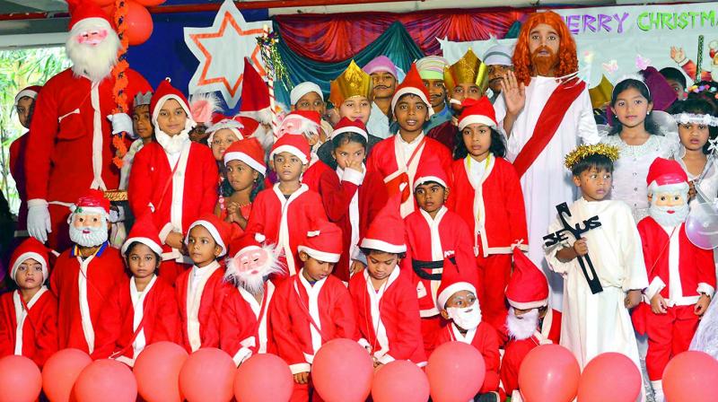 Children don the vrole of Santa Claus as part of Christmas celebrations organised at their school in Visakhapatnam on Friday. (Photo: DC)