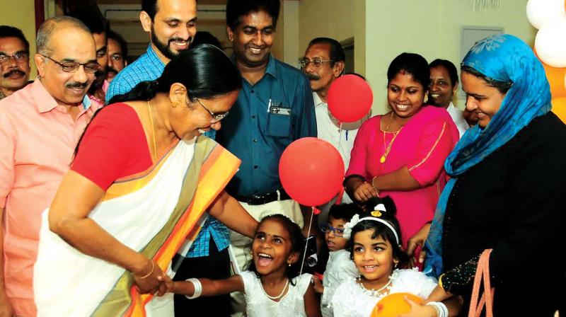 Health Minister K.K. Shylaja interacts with hearing-impaired children at Kozhikode Government Medical College Hospital on Tuesday. (Photo: DC)