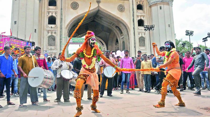Pothurajus dance to the beat of the drums at Bhagya Lakshmi temple at Charminar in Hyderabad on Sunday.  (Pics by P. Surendra)