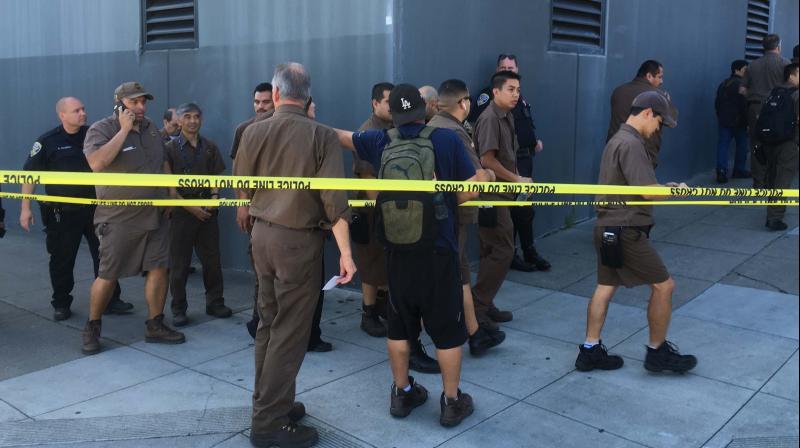 UPS workers gather outside after a reported shooting at a UPS warehouse and customer service center in San Francisco. (Photo: AP)