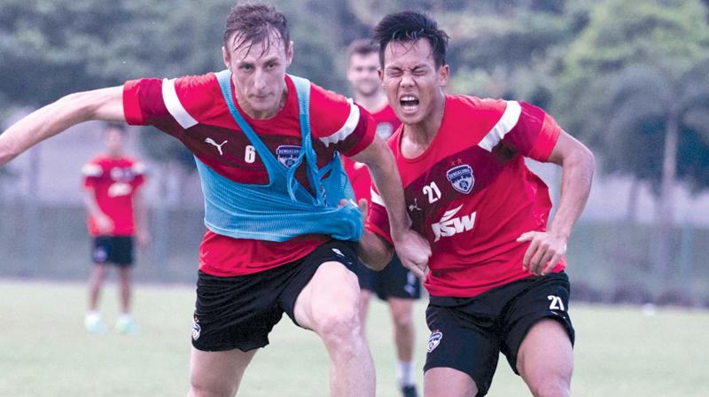 Bengaluru FC defender John Johnson (left) and Udanta Singh vie for the ball at a training session in Cuttack on Saturday, the eve of their Federation Cup final against Mohun Bagan.