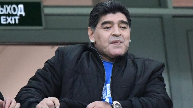 During the game, Maradona drew attention with his antics in the stands  lapping up the adulation from fans, unveiling a poster of himself and seemingly falling asleep at one point. (Photo: AFP)