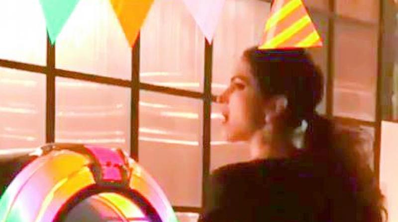 She edited the video with birthday decor and a birthday hat on her head.