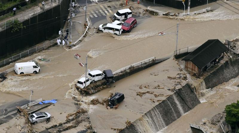 Roads are covered in mud waters after a landslide caused by heavy rains in Aki, Hiroshima prefecture, southwestern Japan. (Photo: AP)
