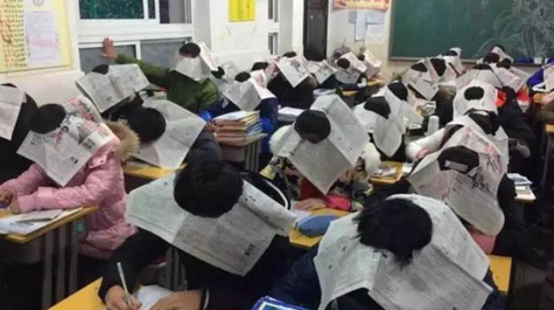 The school, which is situated in the Anhui province, ensured that its pupils wore the unusual headgear in class while attempting their exams. (Credit: Twitter/ @mutazdoceo)