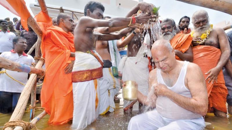 Governor Banwarilal Purohit who inaugurated the Tamirabharani Maha Pushkaram in Tirunelveli district on Thursday, takes a holy dip in the river.  	DC
