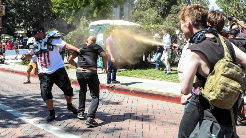 Joey Gibson (black t-shirt), leader of the alt-right Patriot Prayer group, gets pepper sprayed by leftist counter demonstrators in Berkeley, California. (Photo: AFP)