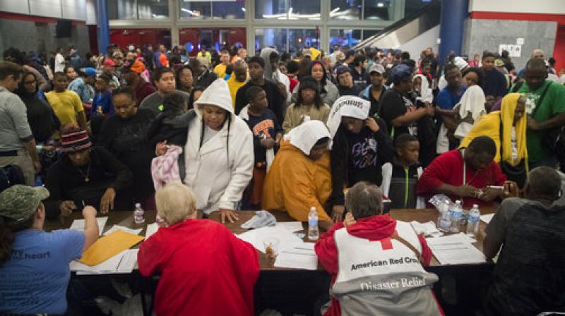 Thousands take shelter from the Tropical Storm Harvey at the George R. Brown Convention Center in Houston. (Photo: AP)