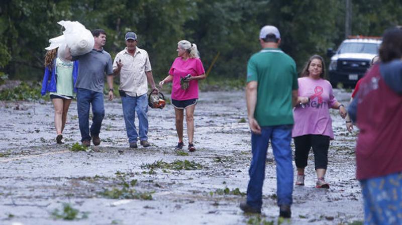Neighbors gather supplies to help move debris from homes along Highway 18 in Fayette, Ala., after a tornado went through Fayette County. (Photo: AP)