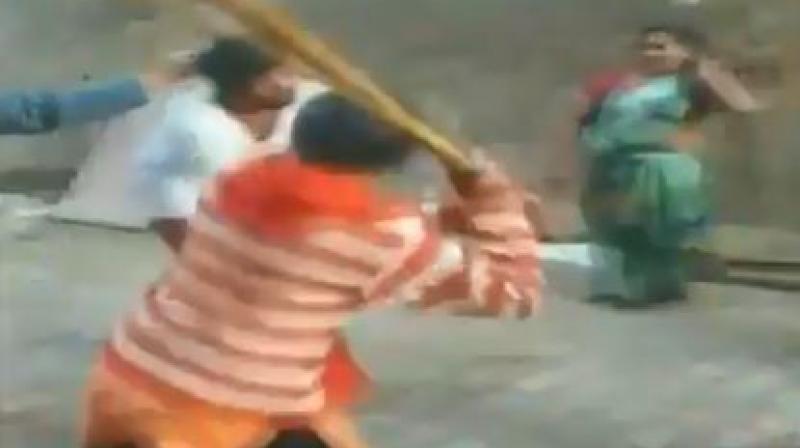 The video shows women beating up the priest who, in a white kurta and with bare legs, tries to defend self. (Photo: Twitter | Screengrab)