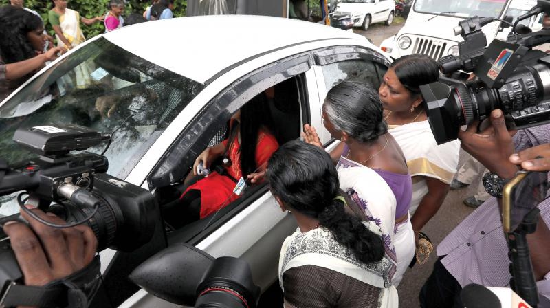 Protesters block a woman journalist at Nilakkal base camp on Tuesday. 	Image; DC