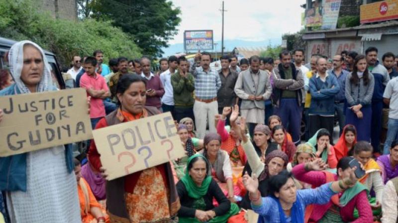 People hold placards block a road during a protest demanding justice for the school girl who was raped and murdered in Shimla. (Photo: PTI)