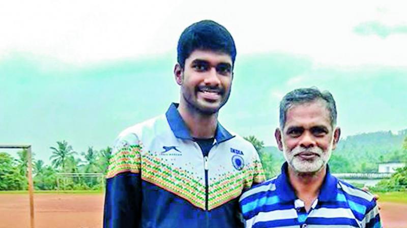 Johnson poses with his childhood coach Peter K.M.