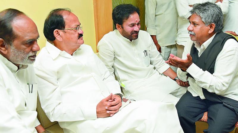 Union minister M. Venkaiah Naidu listens to MRPS chief Manda Krishna Madiga as TS BJP leaders Dr K. Laxman and G. Kishan Reddy look on, in Hyderabad on Sunday. (Photo: DC)