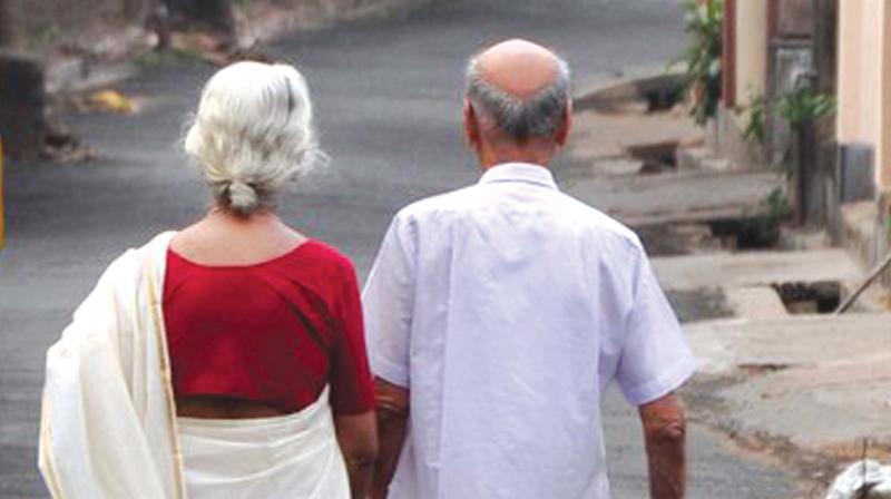 Old couple take care of each other as they walk along the road. (Photo: ANUP K. VENU)