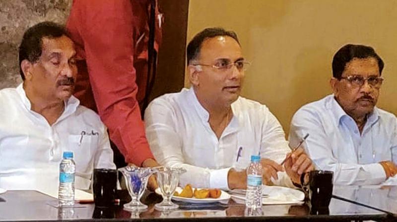 KPCC president Dinesh Gundurao, Deputy Chief Minister Dr G. Parameshwar and Minister for Large and Medium Industries K.J. George during a meeting of the Congress on mayoral election in Bengaluru on Wednesday 	(Photos:KPN)
