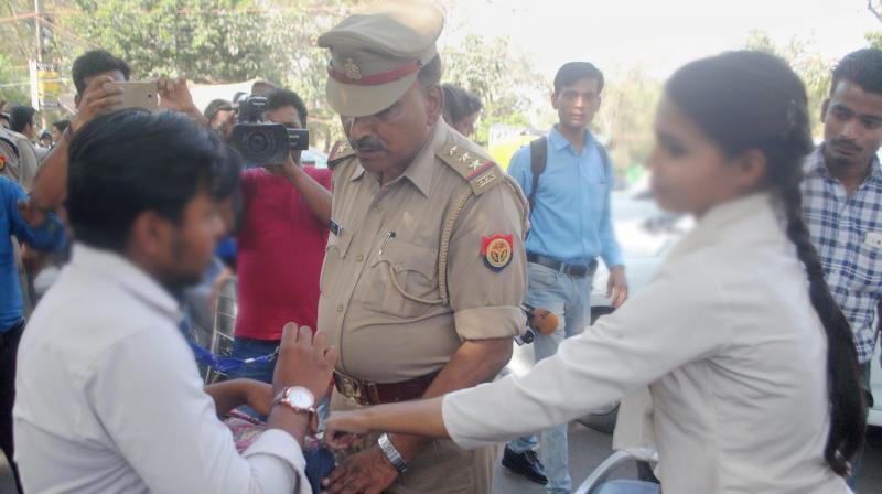 Anti-Romeo squad of police hauls up a youth in Lucknow on Wednesday. \Anti-Romeo squads\ ordered by new Chief Minister of Uttar Pradesh, Yogi Adityanath have started work across the state. (Photo: PTI)