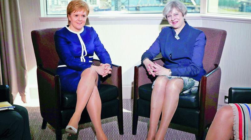 UK Prime Minister Theresa May, right, with Scottish First Minister Nicola Sturgeon. (Photo: AP)