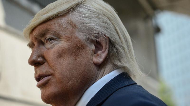A Donald Trump impersonator poses outside the US embassy in Hong Kong. (Photo: AFP)