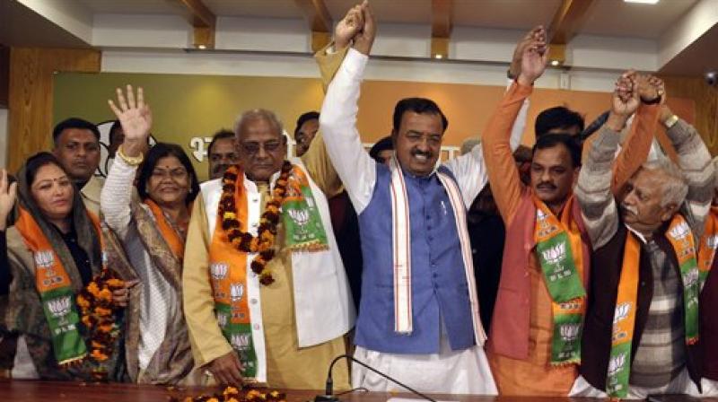 BJP state president Keshav Prasad Maurya with Thakur Dalbeer Singh of Lok Dal and other leaders from different parties after they joined BJP at party office in Lucknow. (Photo: AP)