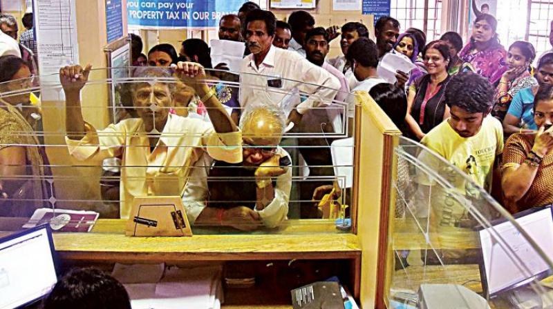 People wait for their turn to exchange demonitised currency notes at a bank in Bengaluru. (Photo: DC)