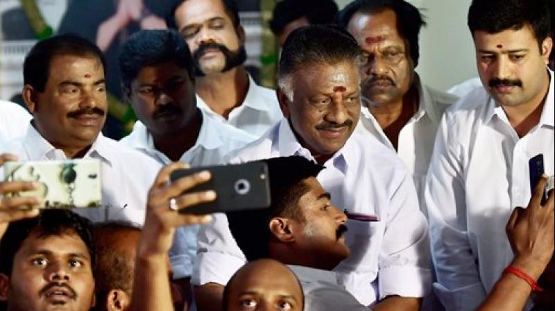 Chief Minister O Panneerselvam with supporters at his residence in Chennai on Sunday. (Photo: PTI)
