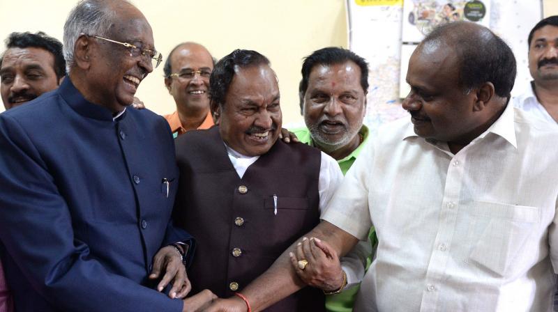 Council chairman D. H. Shankaramurthy being greeted by JD(S) state chief H.D. Kumaraswamy after winning the trust vote.