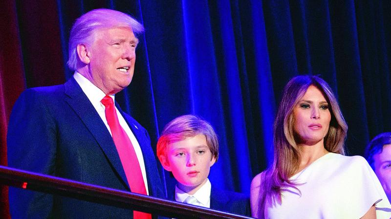 File photo of President-elect Donald Trump, left, arrives to speak at an election night rally with his son Barron and wife Melania, in New York. (Photo: AP)