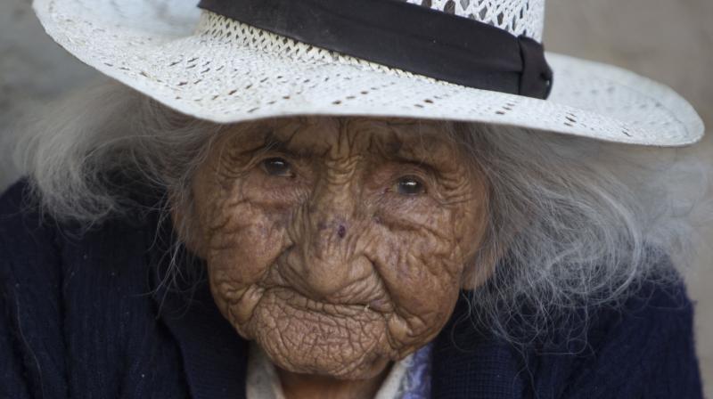 In this Aug. 23, 2018 photo, 117-year-old Julia Flores Colque eyes the camera while sitting outside her home in Sacaba, Bolivia. (Photo: AP)