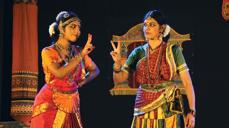 Revathi performing with her troupe member.