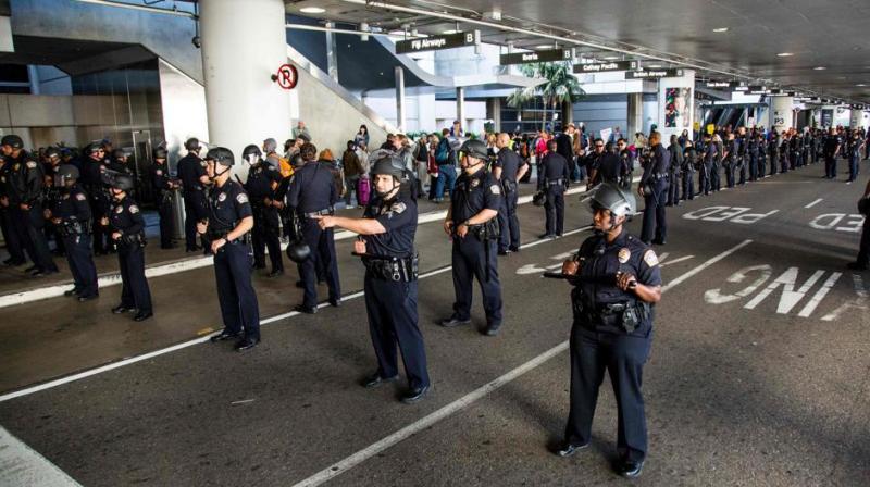 Los Angeles Airport police guard a protest against the executive order by US President Donald Trump, banning immigrants from seven majority-Muslim countries at Los Angeles International Airport in Los Angeles, California. (Photo: AFP)