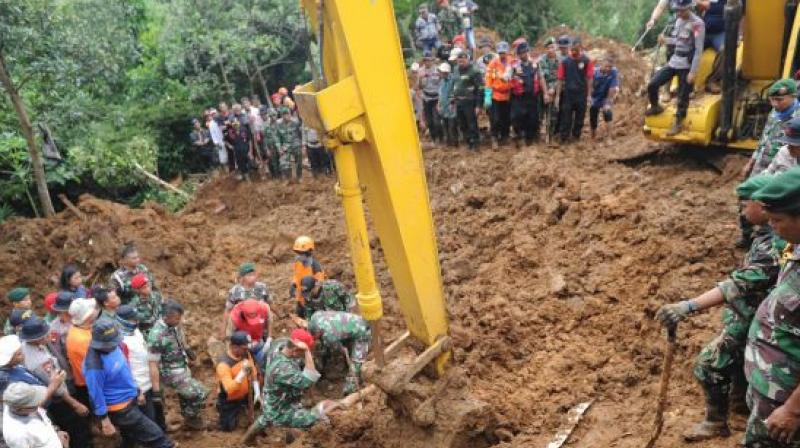 On Monday, rescuers retrieved a body from villages ravaged by landslides in the hilly West Java resort town of Puncak and are still searching for at least eight others. (Photo:AP)