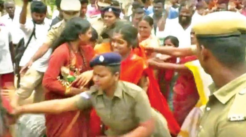 Police remove Nithyananda followers from encroachment in Thiruvannamalai district on Friday. (Source: Polimer)