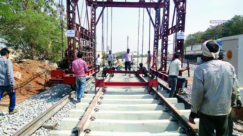 Workers lay the tracks between Moulali and Ghatkesar. (Photo: DC)