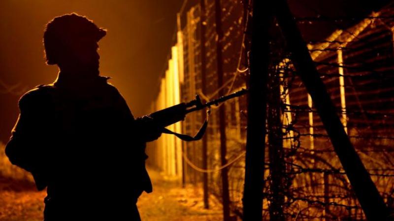 A Border Security Force (BSF) person during a night patrol near the fence at the India-Pakistan International Border at the outpost of Akhnoor sector, about 40 km from Jammu. (Photo: PTI)