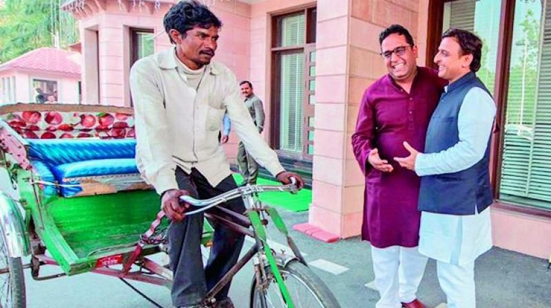 UP Chief Minister Akhilesh Yadav with rickshaw-puller Maniram and Paytm CEO Vijay Shekhar Sharma at his residence on Friday  via web