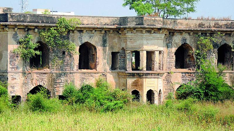 The Mian Mishq Mahal at Attapur lies in severe neglect  as the surrounding vegetation takes over its walls.