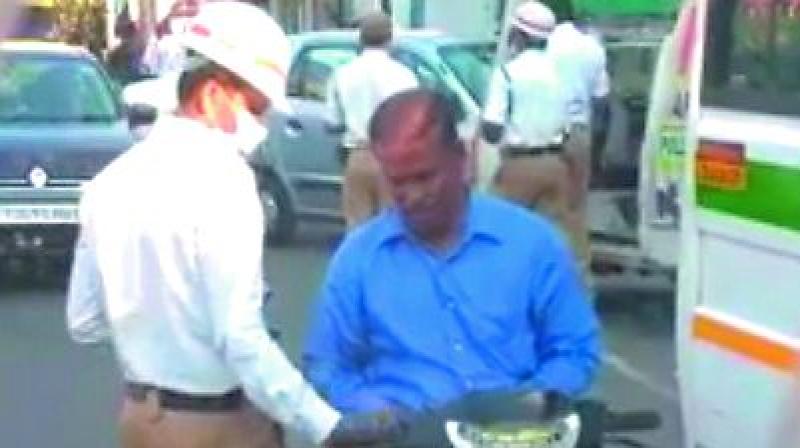 A traffic home guard who was filmed purportedly taking a bribe is facing the sack. The video was posted on the traffic police website.